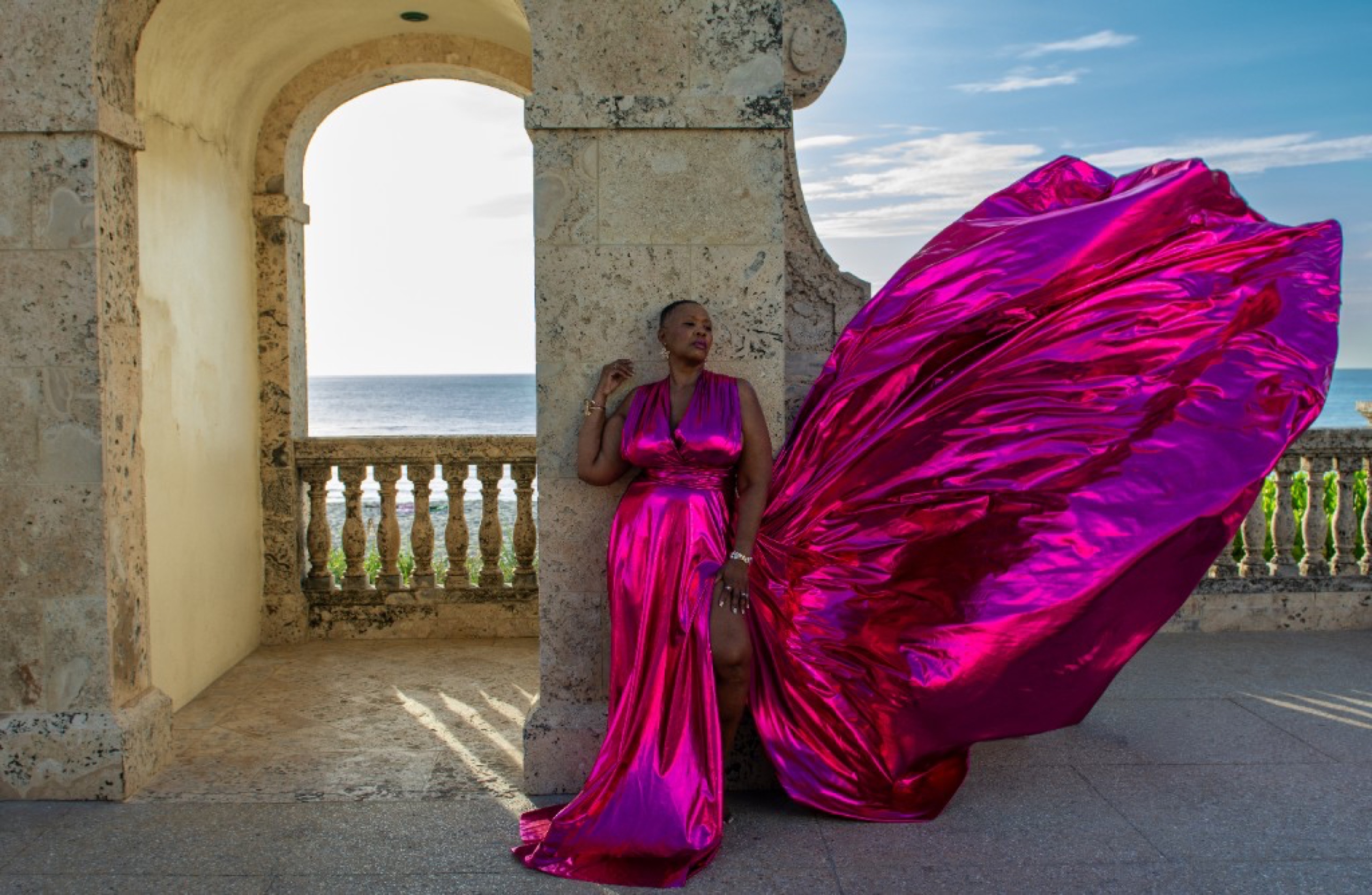 Flying dress photoshoot at the Worth Avenue Clocktower — metallic magenta gown