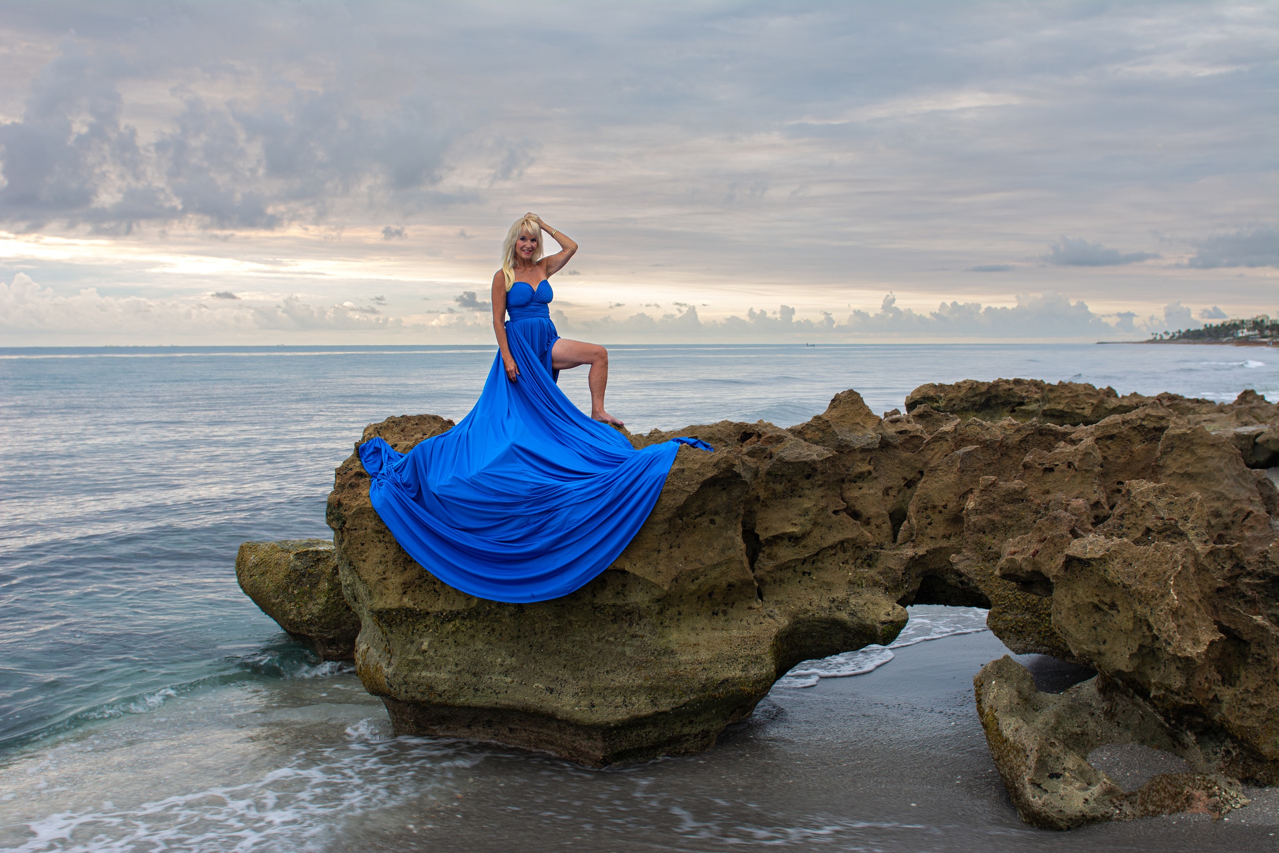Flying dress photoshoot at Coral Cove Park — royal blue gown at golden hour