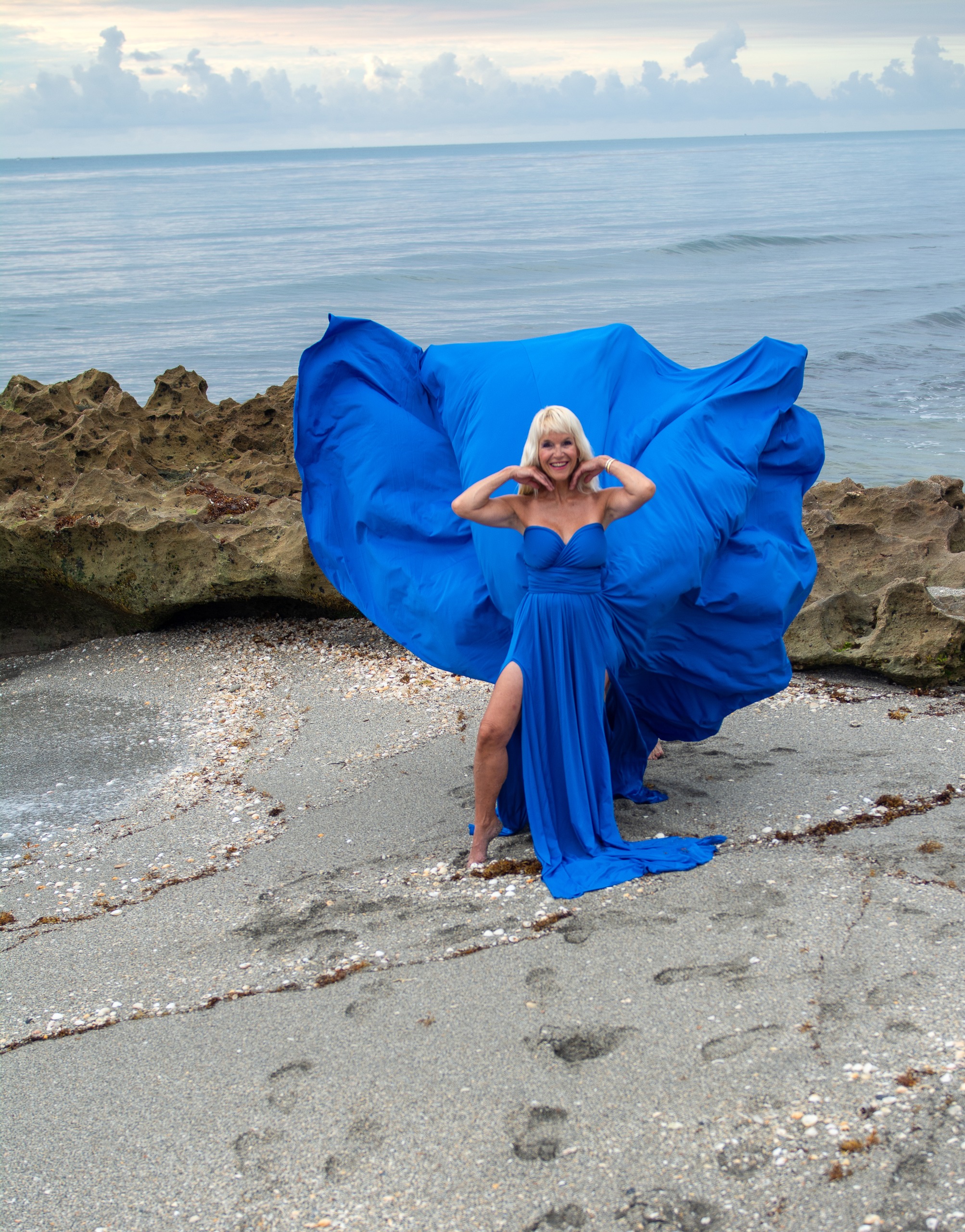 Flying dress photoshoot on the beach — royal blue gown with flowing train